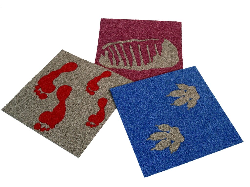 Découpes et incrustations dans dalles de moquette.